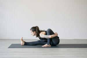 woman in white t-shirt and blue denim jeans lying on floor