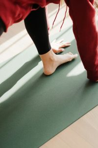 a person standing on a yoga mat on the floor